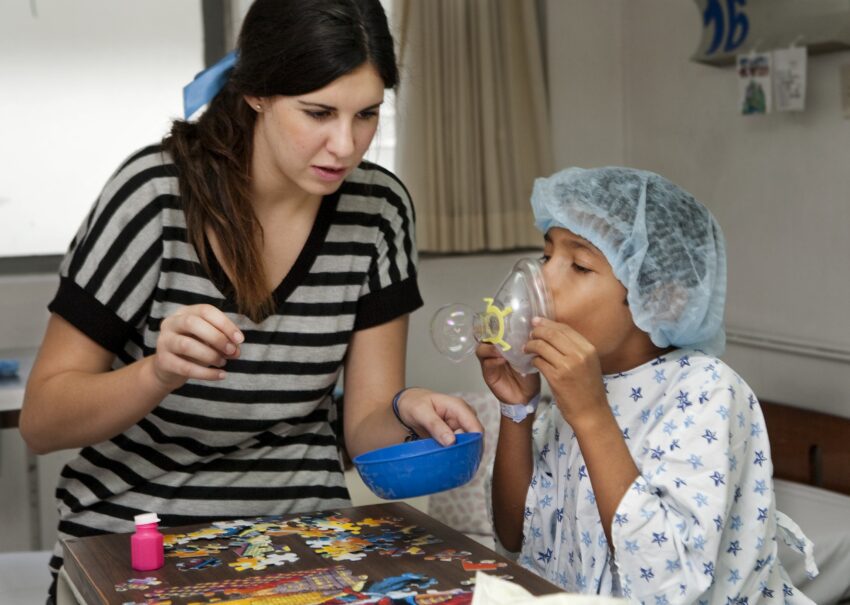 A volunteer in Mexico reverses an oxygen mask so a child with a cleft condition can blow a bubble for the first time.