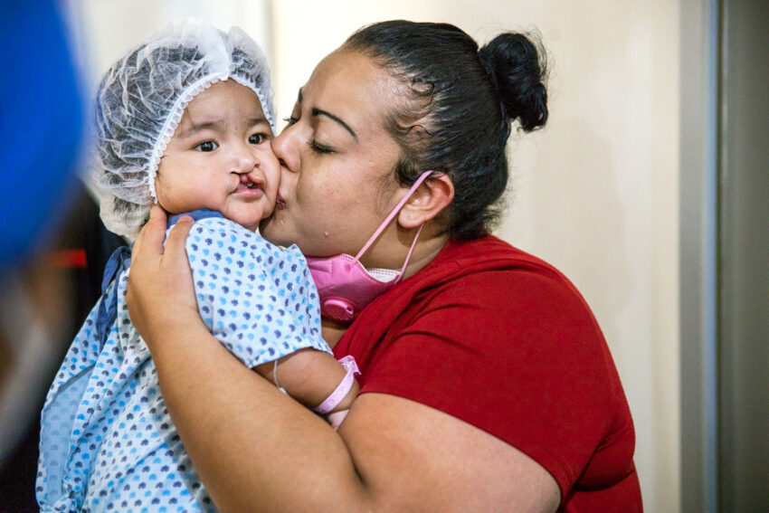 Lilia being kissed by her mom, Valeria