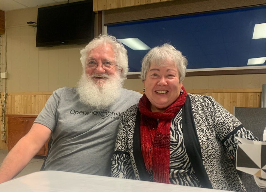 Man and woman, smiling at the camera.