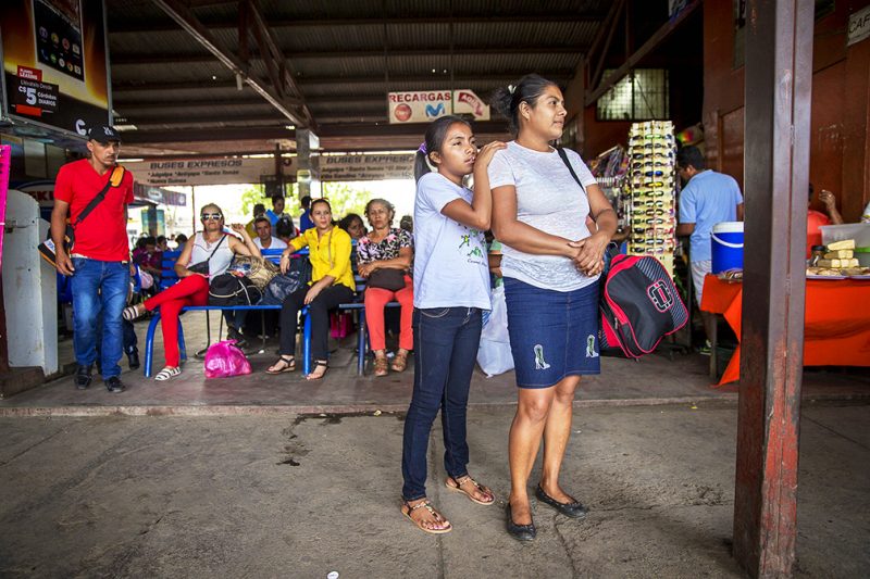 Iris waiting for the bus with her mother